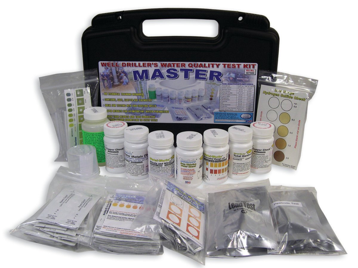 Well Driller's Water Quality Test Kit with various bottles, testing strips, and instructions laid out in front of a black carrying case.